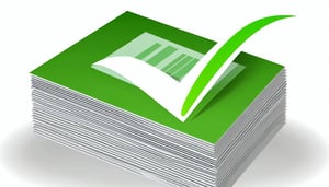 A green tick on a neat stack of paperwork